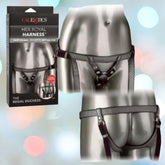 The image features the front and back view of an opulent harness named "Her Royal Harness The Regal Duchess Pewter" from CalExotics. This crotchless harness, crafted from vegan leather, is displayed on a silver mannequin. An adjustable buckle offers comfort, and the packaging appears on the left side of the image.